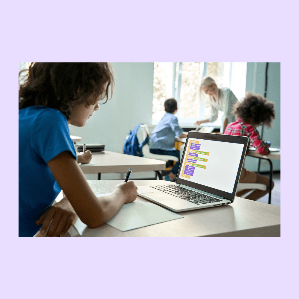 High school student programming a game on their laptop.